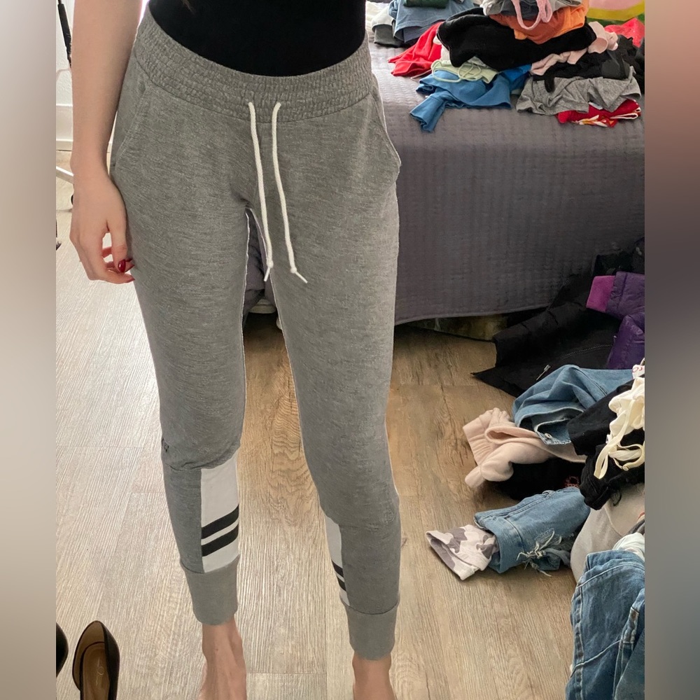 Pink grey joggers with black detail on the bottom side